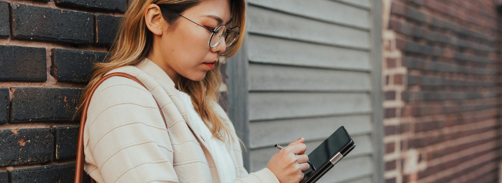 A female doctor wearing a mask, reviewing reports on a computer