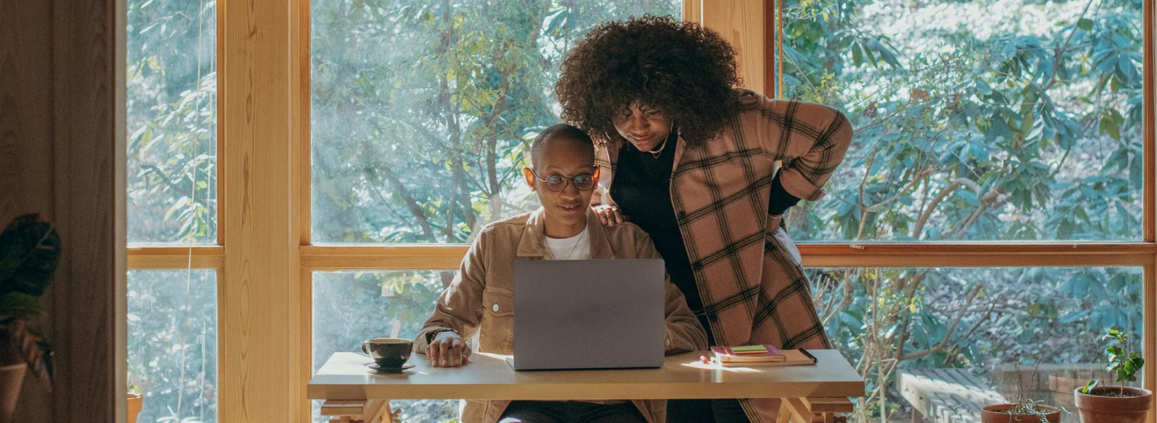 A female doctor wearing a mask, reviewing reports on a computer